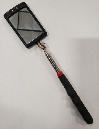 Telescoping mirror used to view the milliamp meter during a test fire
